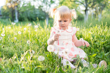 Little girl is playing on the grass