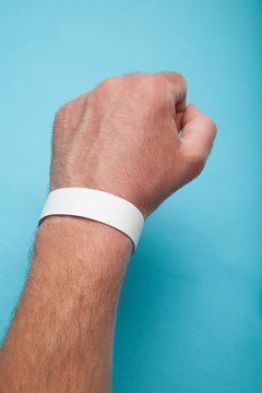 Empty white bracelet on his arm, a mock-up.
