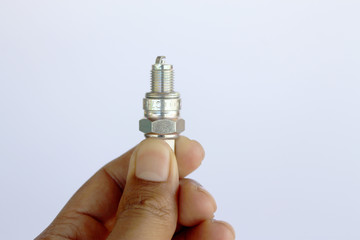 New spark plug in hand before use.