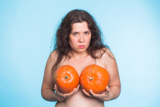 Pumpkins on a female breast - concept silicone breast and plastic surgery.