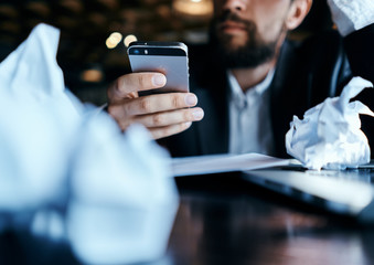 a man with a beard and a touch phone in his hand