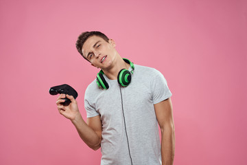 man with a joystick and green headphones