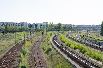 Fototapeta na wymiar Railway tracks curve, with cityscape in the background