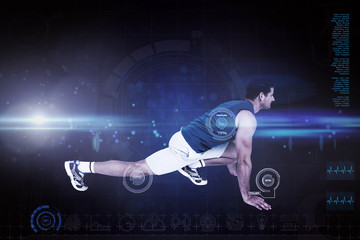Side view of a fit man doing stretching exercise against blue dots on black background