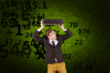 Young geeky businessman holding briefcase against green background with vignette