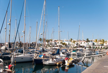 Fototapeta na wymiar Yachts and sailing boats anchored at marina on Grand Canary Island