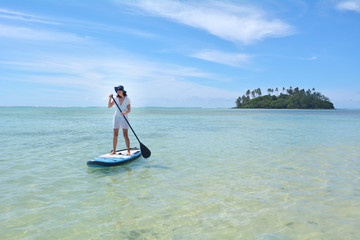 Young woman on a Stand Up Paddle Board paddle boarding