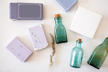 Lavender soap, paper boxes, vintage bottles on a white background, top view. For mockups, presentations.