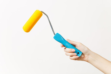 Close up of female hand horizontal holds paint roller for wall painting isolated on white background. Instruments for renovation apartment room. Repair home concept. Copy space for advertisement.