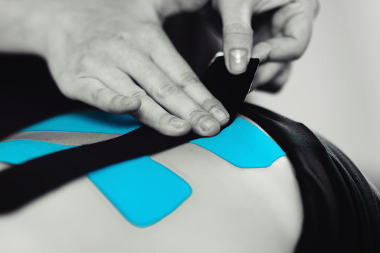 Back Treatment With Blue Kinesiology Tape