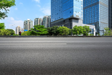 empty asphalt road and modern commercial buildings