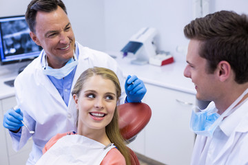 Fototapeta na wymiar Dentists interacting with female patient