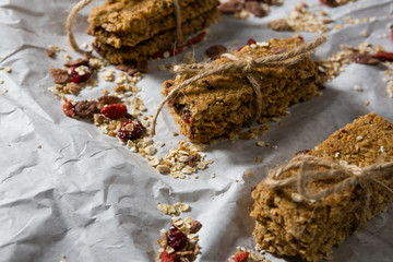 Granola bars tied with string on wax paper