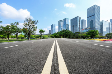 empty asphalt road and modern commercial office buildings