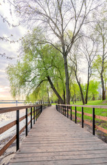 Footbridge, close to the Dnieper river, in the Natalka park in Kiev, Ukraine, during a cloudy spring morning