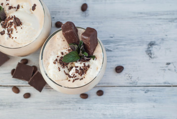 Iced Mocha Coffee with Whip Cream, Summer Drinking times. Coffee Beans. rustic textured Wooden Background. Mint Leaves