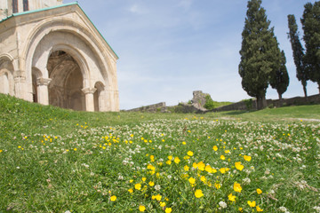 Georgia temple with flowers and grass in the foreground