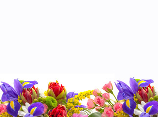Bright spring bouquet of tulips, roses, irises on a white background