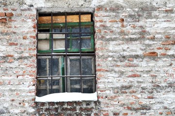 a broken window on the abandoned house
