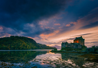 Fototapeta premium Eilean Donan Castle and a dramatic sunset sky on a Halloween evening