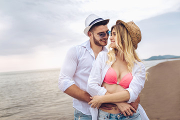 Fototapeta na wymiar Lovers couple in love having fun dating on beach.