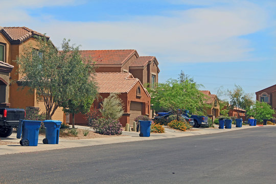 Blue Trash Cans Line The Street On Trash Day In A Tucson Neighborhood With Blue Sky Copy Space.