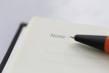The pen tip points to the Note letter hand have copy space.
