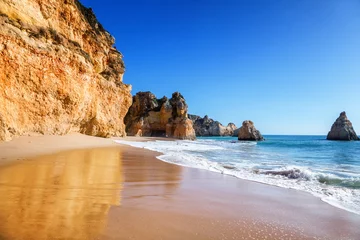 Fotobehang beautiful sea view with secret sandy beach among rocks and cliffs in Algarve, Portugal © olezzo