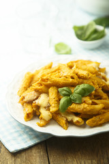 Pasta with creamy pumpkin sauce and fresh basil
