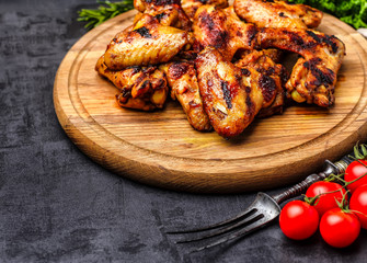 Grilled or oven roasted chicken wings glazed with barbecue sauce