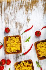 Various pasta in wooden bowls