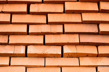 Fototapeta premium Rows of red bricks ready for transport. Background.
