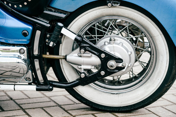 Fototapeta premium Motorcycle wheel with disk brakes system and metal spokes. Closeup detailed photo of motorbike forks and tire. Different parts of two-wheeled vehicle. Transportation. Modern driving technologies.