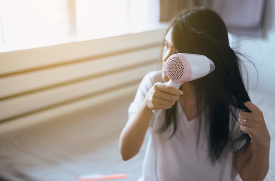 Female drying her long hair with dryer,Young asian woman drying  hair with towel