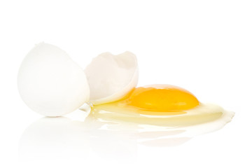 One cracked white chicken egg isolated on white background two pieces of shell and raw fresh yolk.