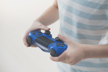 holding a game console controller playing video games.