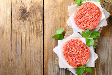 Raw minced meat for home made grill burgers cooking with spaces and herbs.
