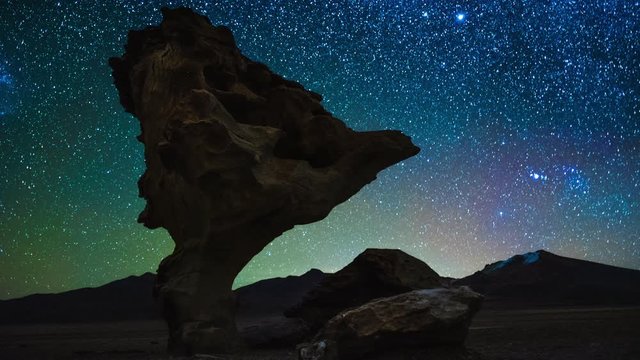 Timelapse of the night sky with stars and rock formation named Arbol de Piedra (Stone Tree), Bolivia
