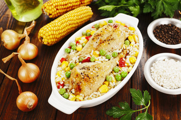 Chicken legs baked with rice and vegetables