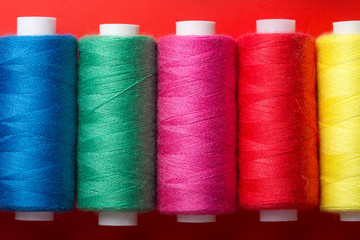 colored thread on bobbins red yellow green blue
