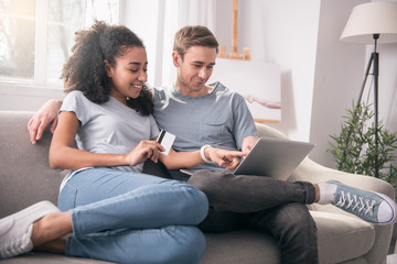 I want this. Nice happy woman pointing at the laptop screen while showing what she wants to buy