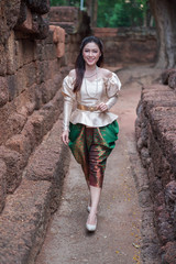 woman in Thai traditional dress is walking