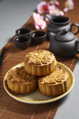 Golden Emerald mooncake on wooden table. Chinese mid autumn festival foods