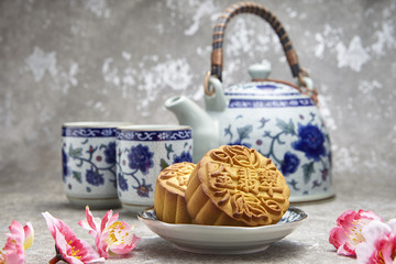 Golden Emerald mooncake on wooden table. Chinese mid autumn festival foods