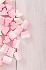 Marshmallows on wooden table. 