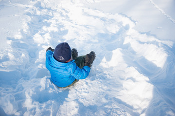 Asian child sliding on snow