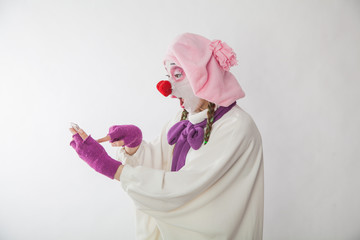 mime girl in a snowman costume with mobile phones in hands. Man with emotions on a white background.