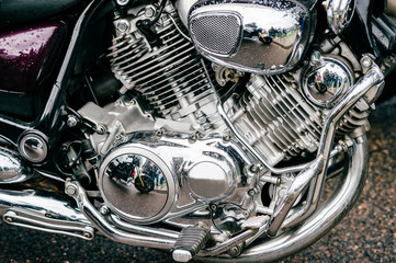 Closeup of motorbike with lots of chrome details. Modern powerful perfomance road motorcycle shiny reflexive surface engine with exhaust pipes.  Vehicle industry.  Two-wheeled vehicle technologies.