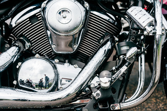 Closeup of motorbike with lots of chrome details. Modern powerful perfomance road motorcycle shiny reflexive surface engine with exhaust pipes.  Vehicle industry.  Two-wheeled vehicle technologies.