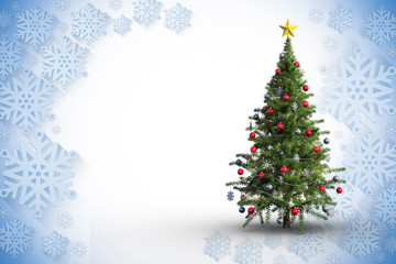 Christmas tree on white background against blue and white snowflake design